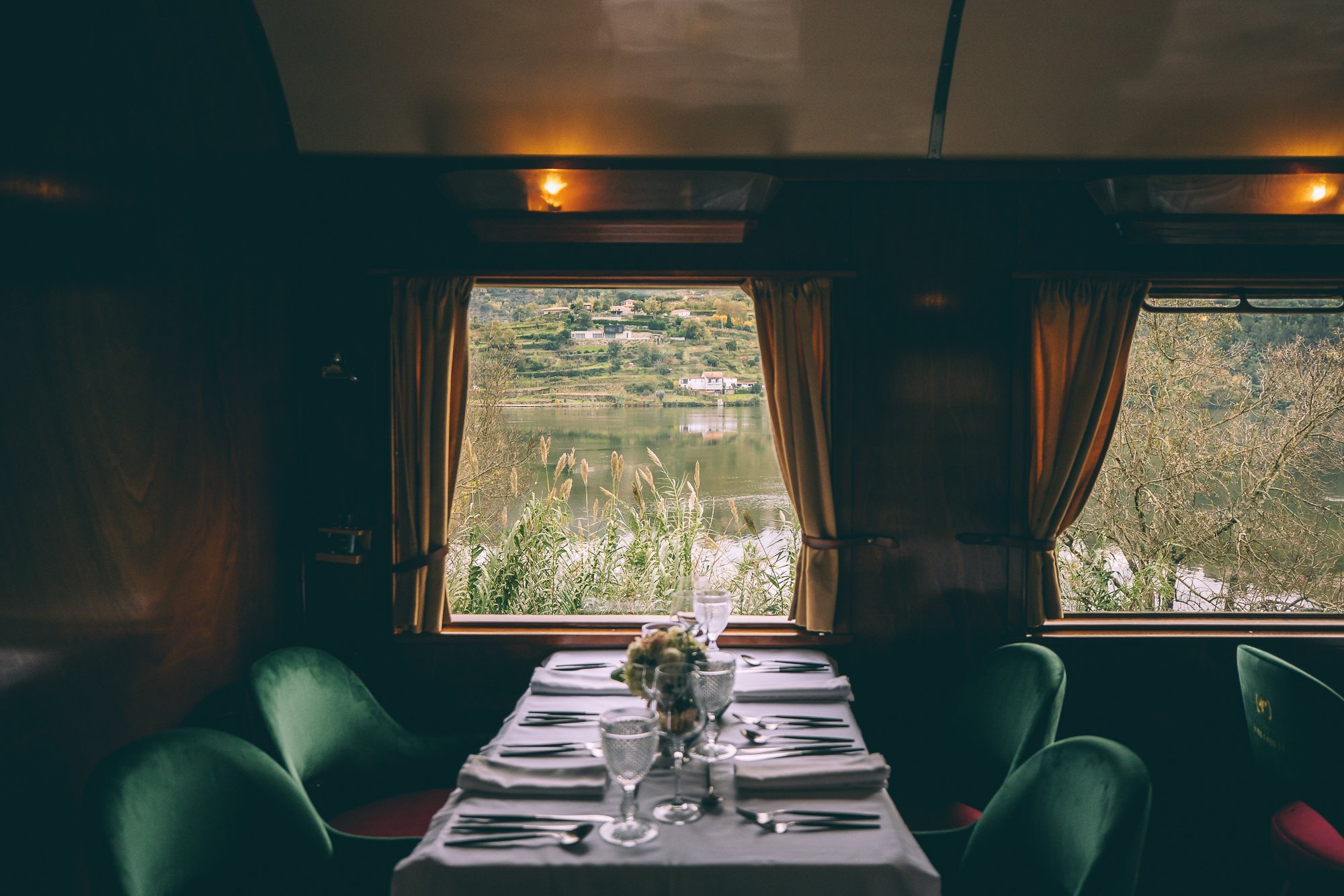 The picturesque Douro Valley unfolds, with terraced vineyards, meandering Douro River, and rolling hills, illustrating the breathtaking scenery witnessed during the Presidential Train journey.