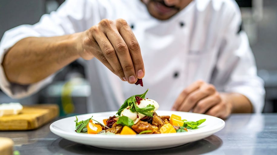 Chef Plating Salad at Restaurant