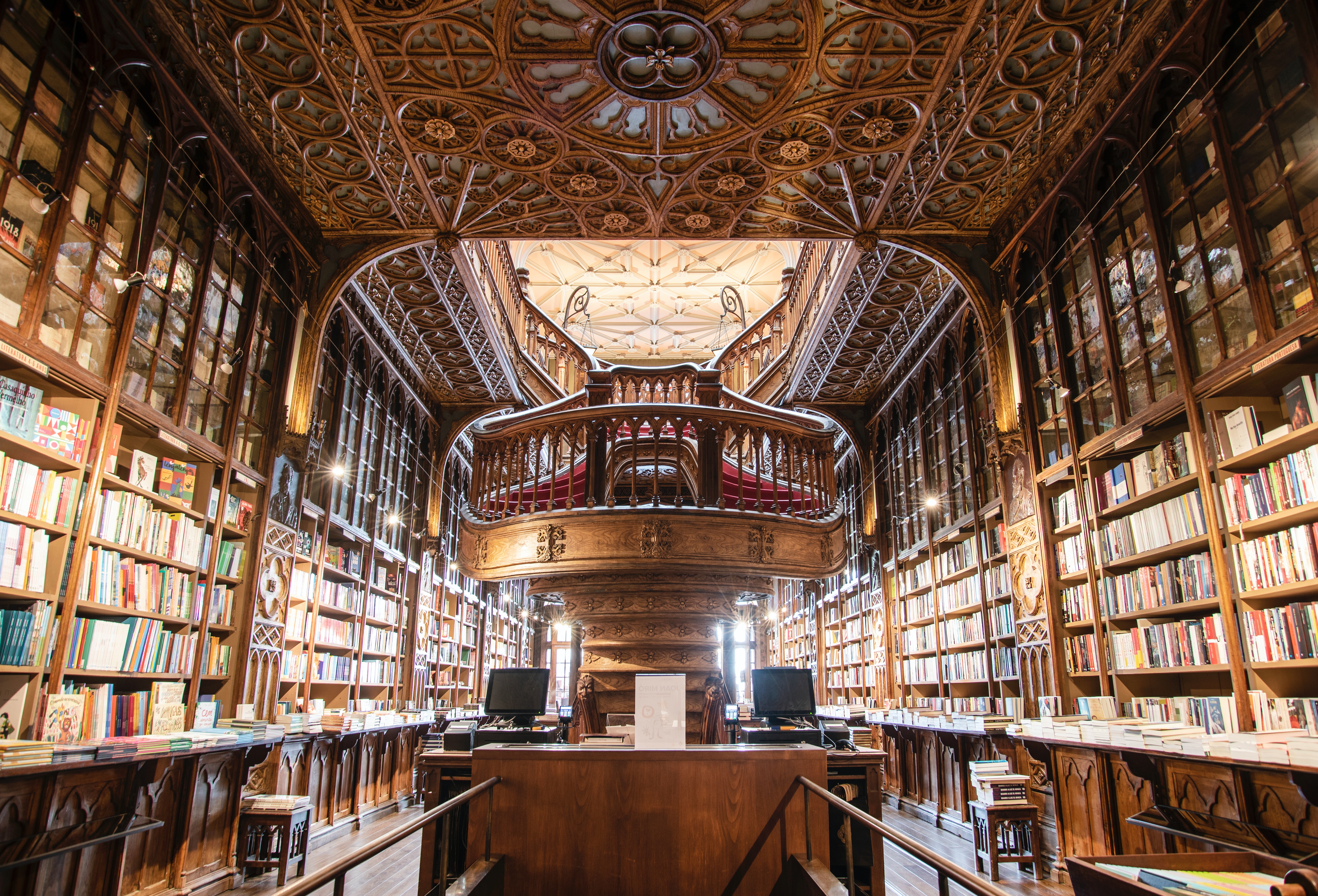 Interior of Livraria Lello, a historic bookstore in Porto, Portugal, known for its stunning Neo-Gothic architecture, intricate wooden staircases, and ornate bookshelves