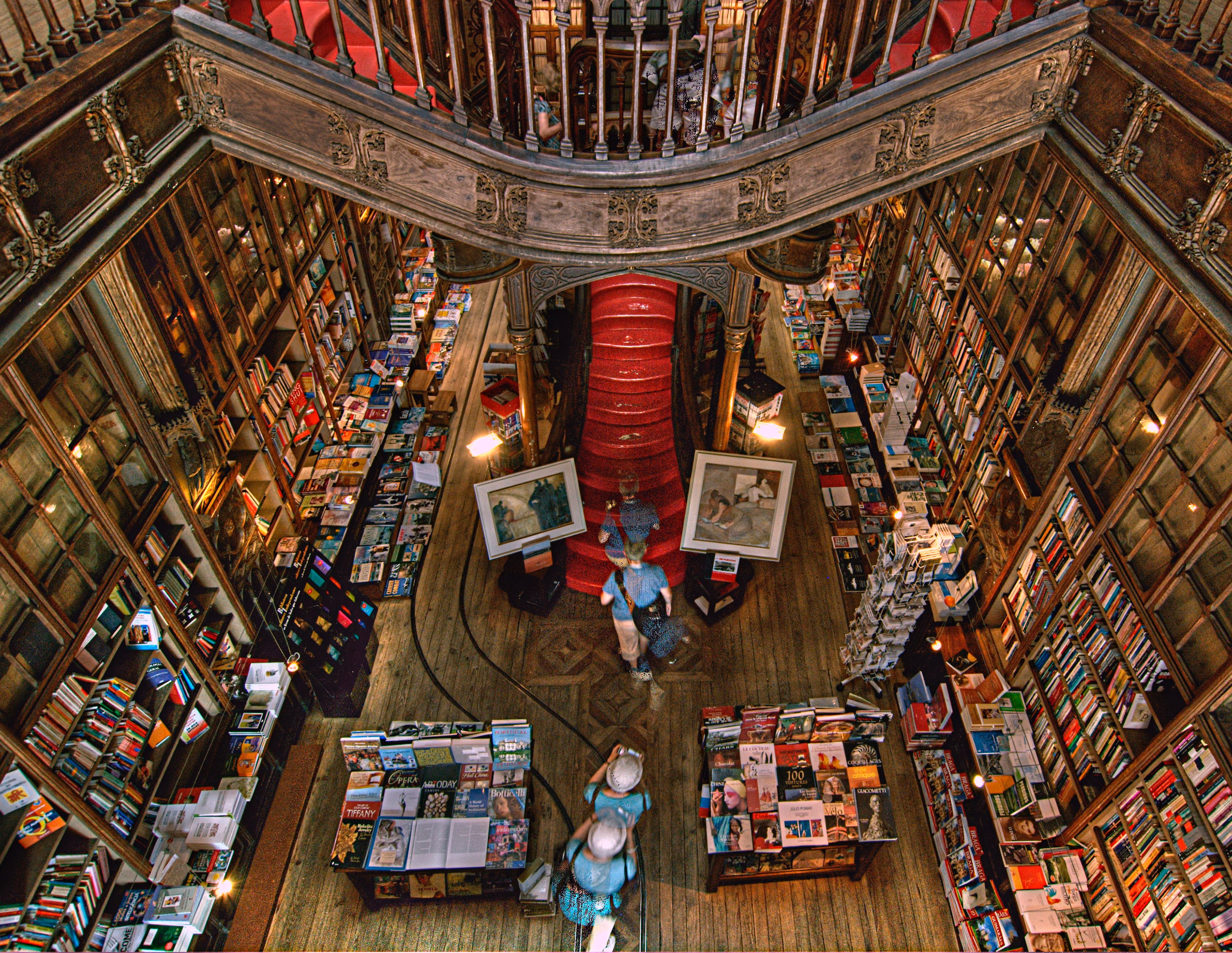 Interior of Livraria Lello, a historic bookstore in Porto, Portugal, known for its stunning Neo-Gothic architecture, intricate wooden staircases, and ornate bookshelves